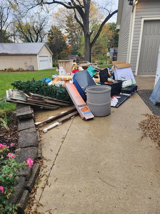 Dumpster being loaded with debris for Roofing Dumpster Rental in Anna